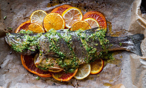 Roasted Whole Sea Bass with citrus slices and herb oil dressing